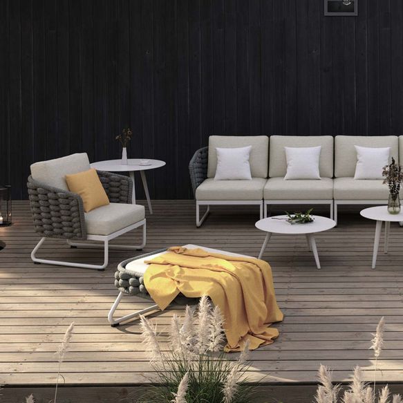 Helle Outdoor-Couch mit Sessel, Hocker und Tischen