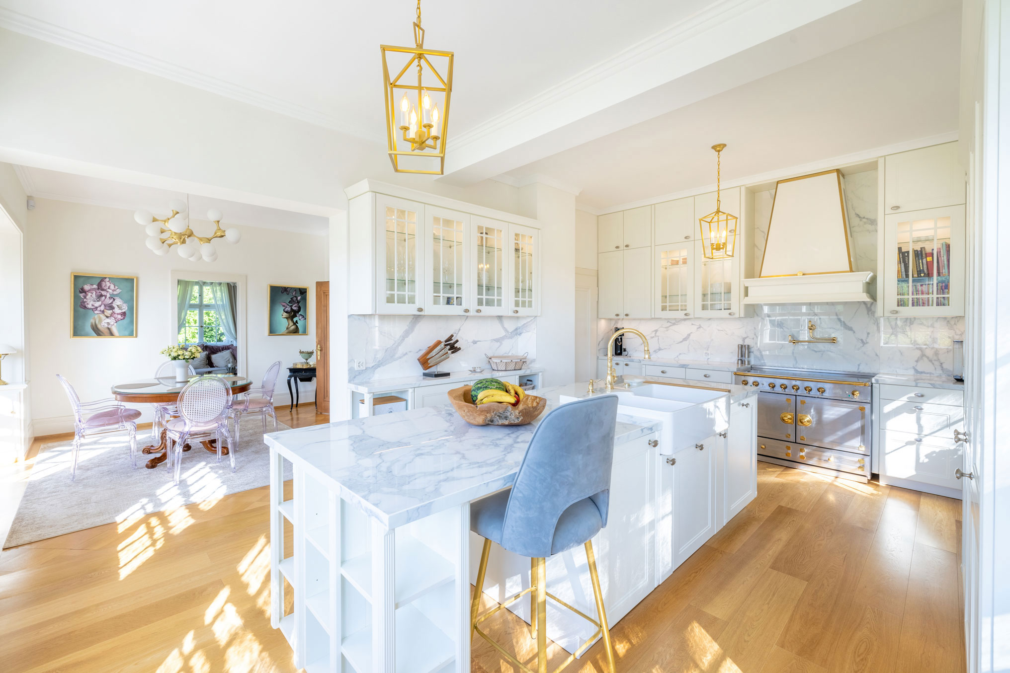 Weiße, elegante Landhausküche mit goldenen Elementen