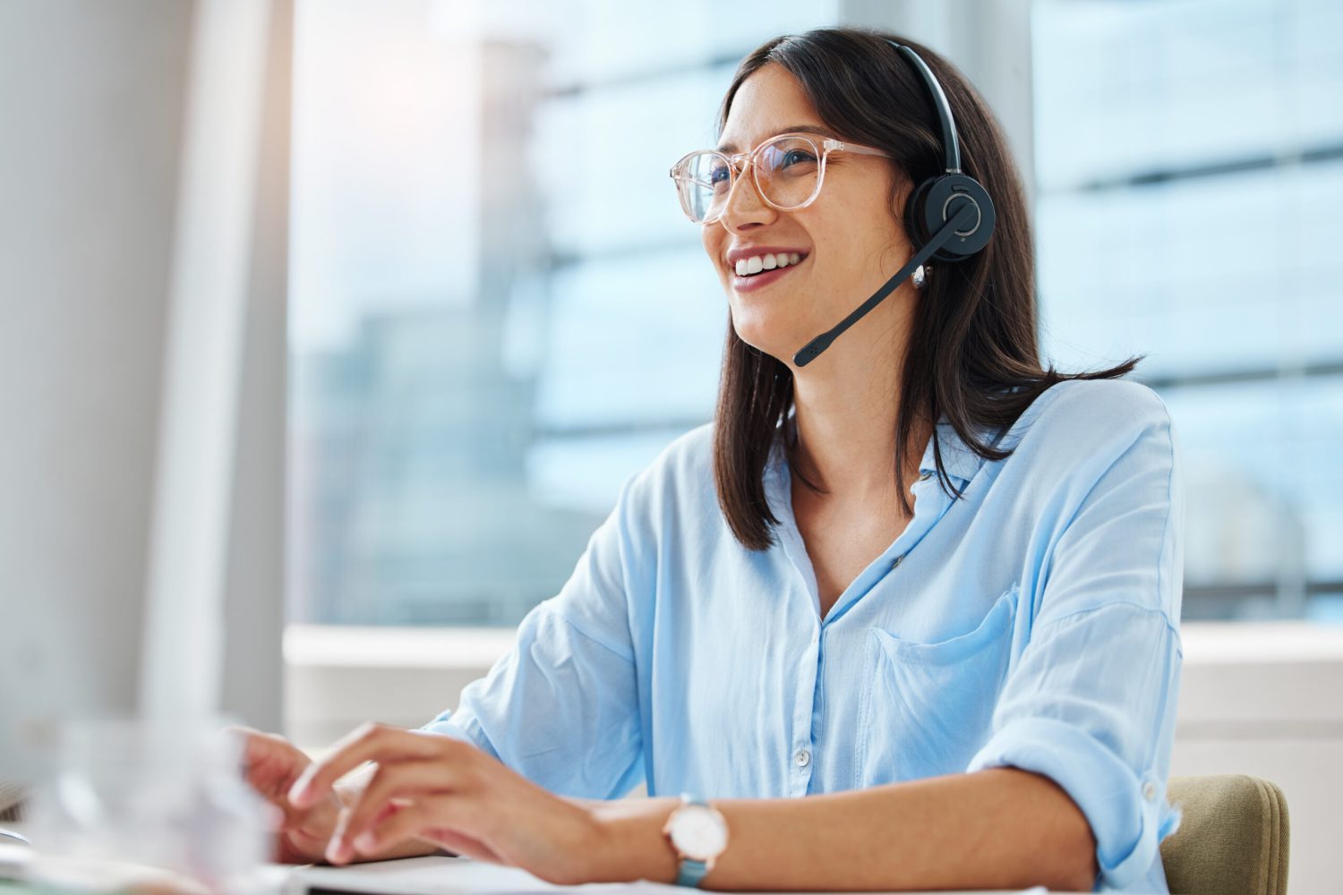 Computer, email or happy woman consultant in call center talking or networking online in telecom office. Smile, girl typing or virtual assistant in communication or conversation at customer services.