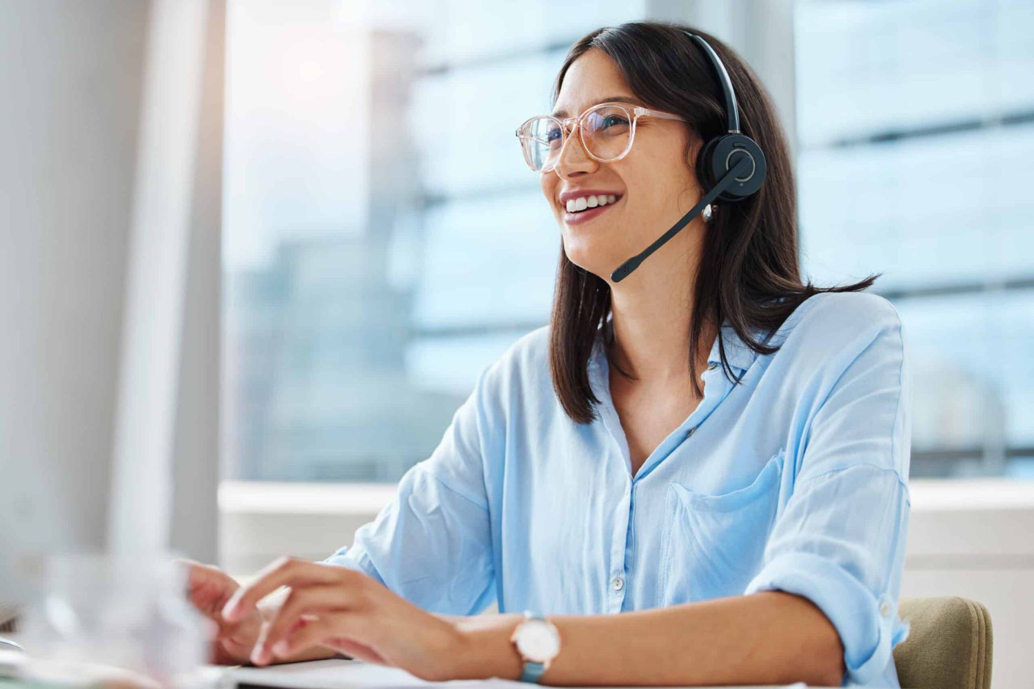 Computer, email or happy woman consultant in call center talking or networking online in telecom office. Smile, girl typing or virtual assistant in communication or conversation at customer services.